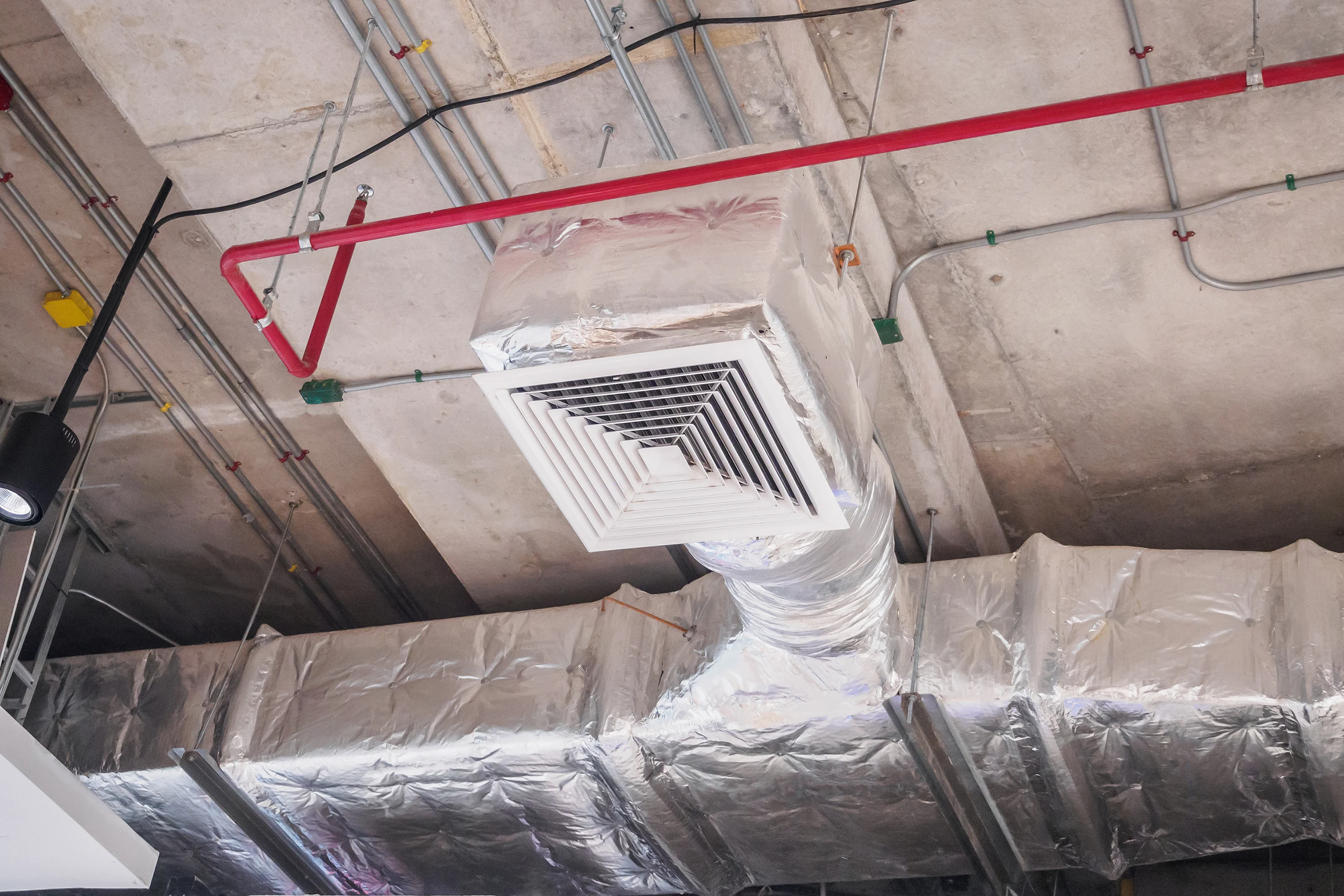 Exposed high-efficiency ductwork system installed in a Phoenix facility.