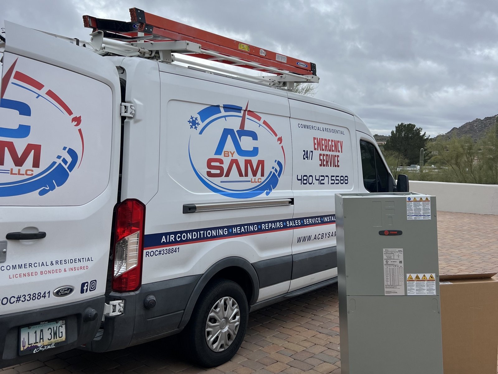Air Dynamics of Tulsa owners Pat and Stephen, standing in front of their truck smiling.
